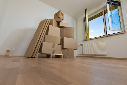 Mover securing furniture inside a van for small removals Stratford
